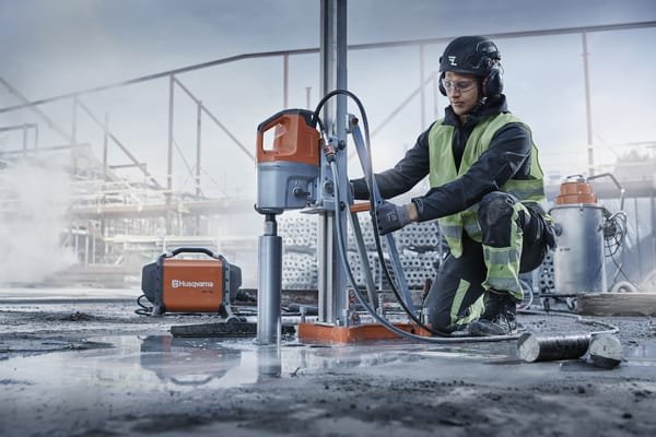 Core drilling rig drilling downward through a suspended concrete floor slab